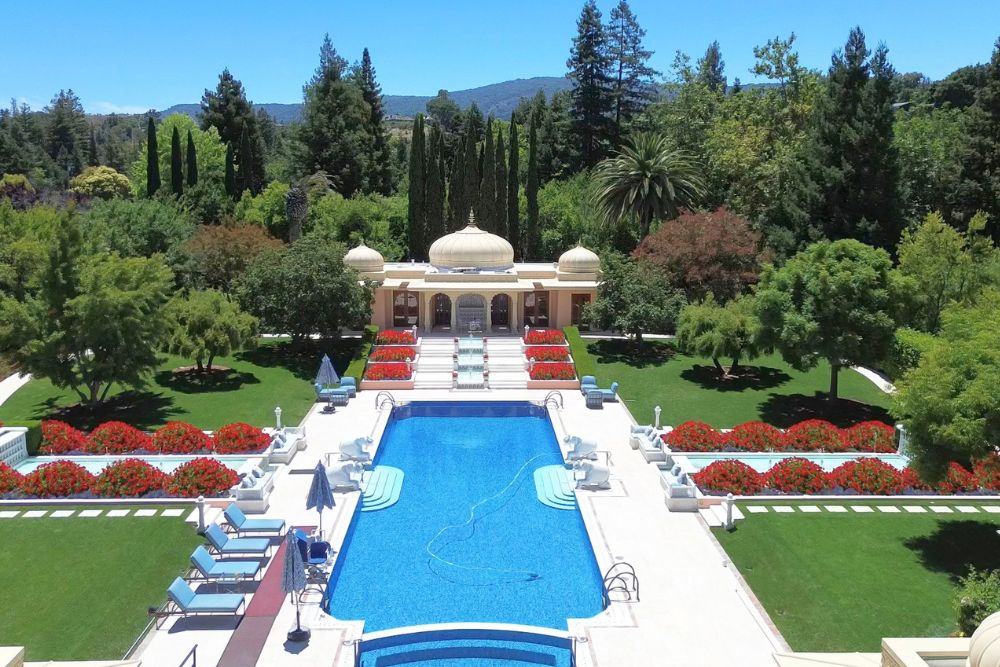 Grand estate pool surrounded by gardens